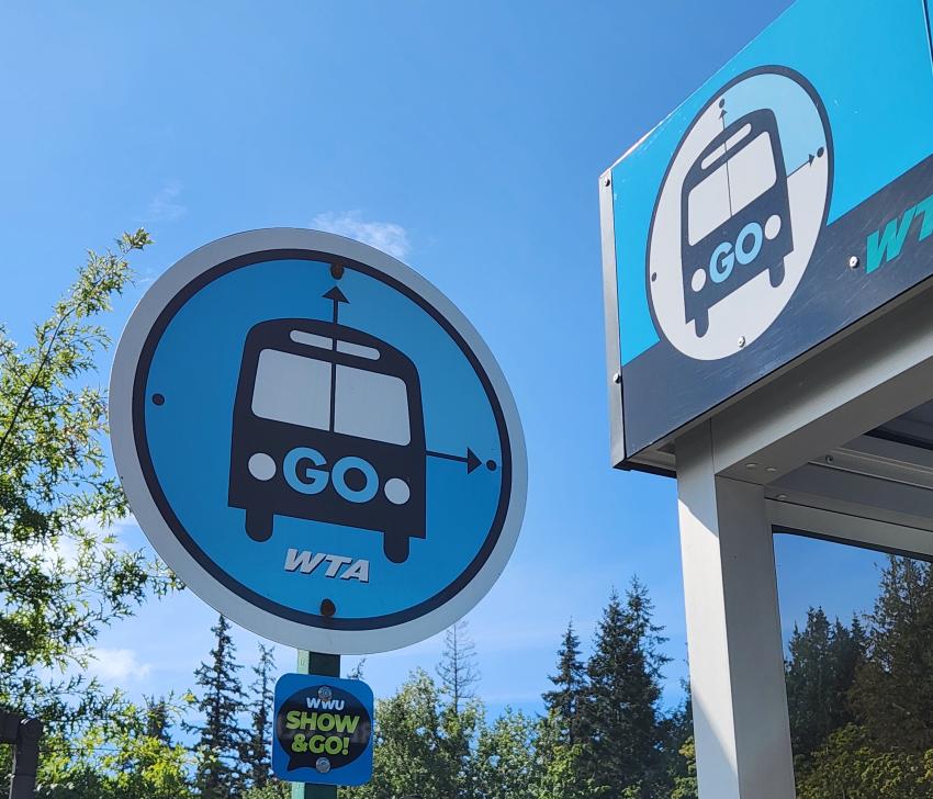 A blue round bus stop sign reading "GO" and "WTA"