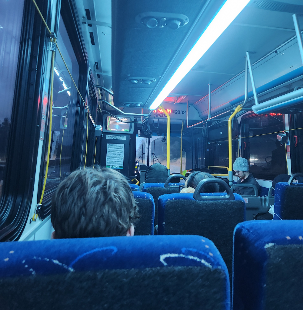 A group of people ride a bus.