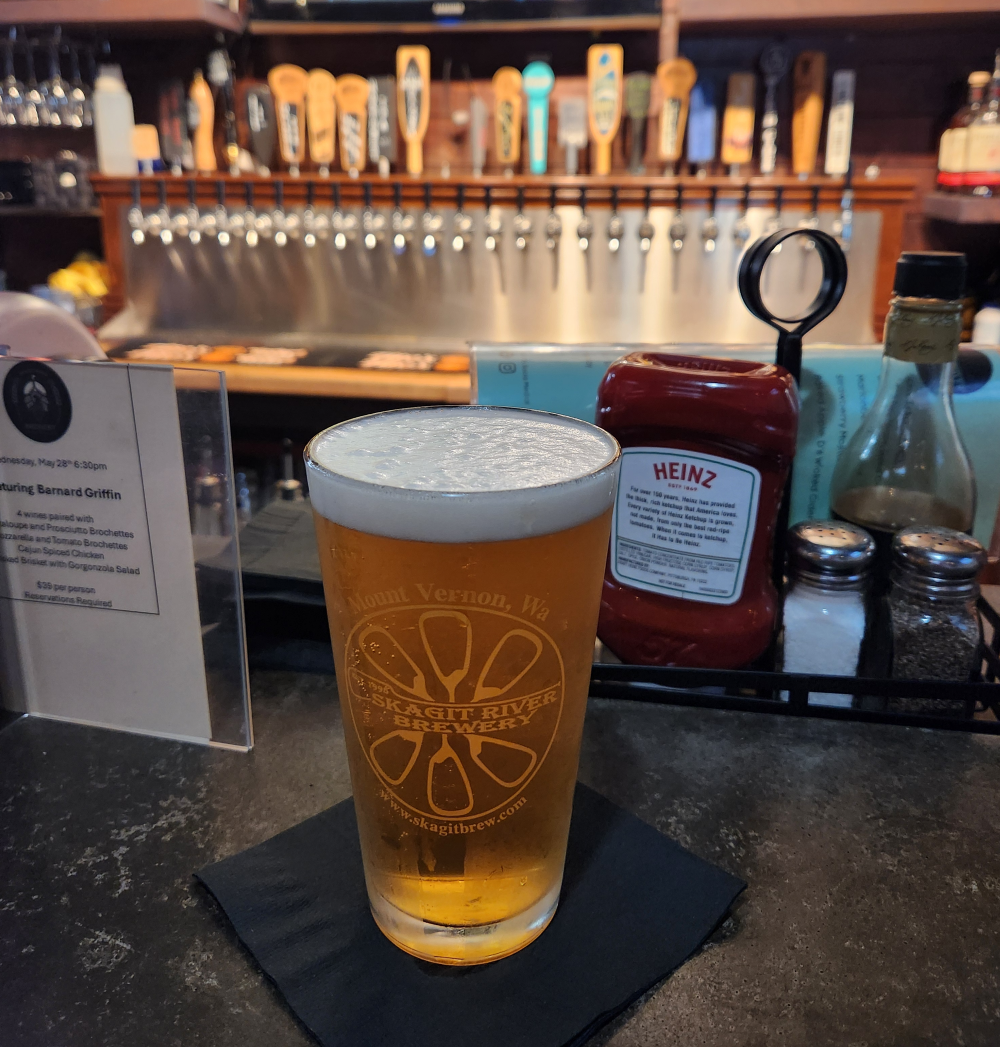 Beer in a pint glass with the logo of Skagit River Brewing.