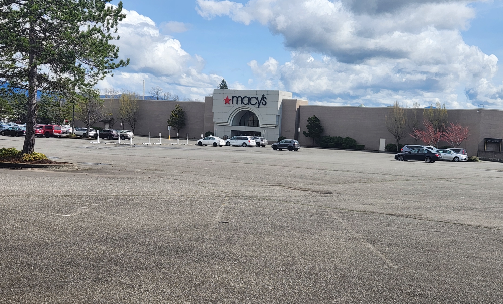 A largely empty shopping mall parking lot outside a Macy's location. (Photo by Michael Grass / BhamByBus)