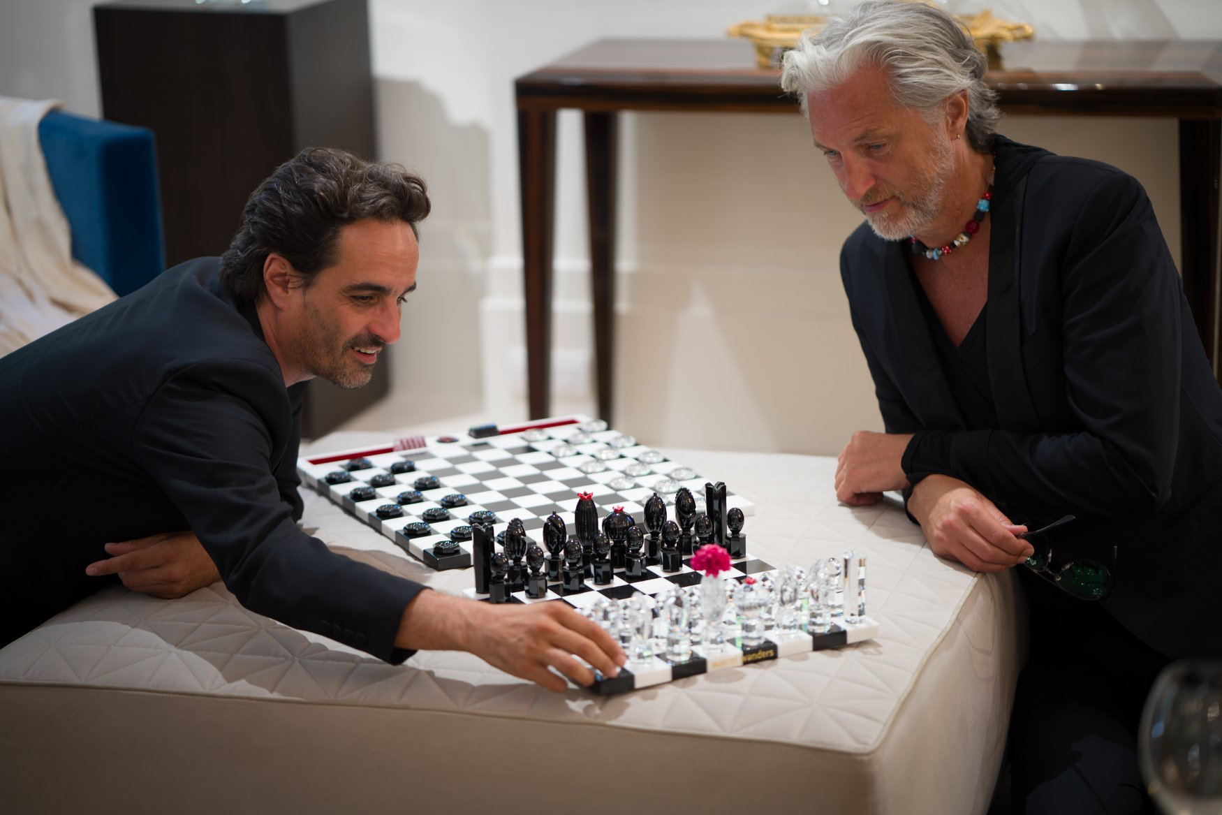 Designers Gabriele Chiave and Marcel Wanders, playing with the Chess set they designed for Baccarat.