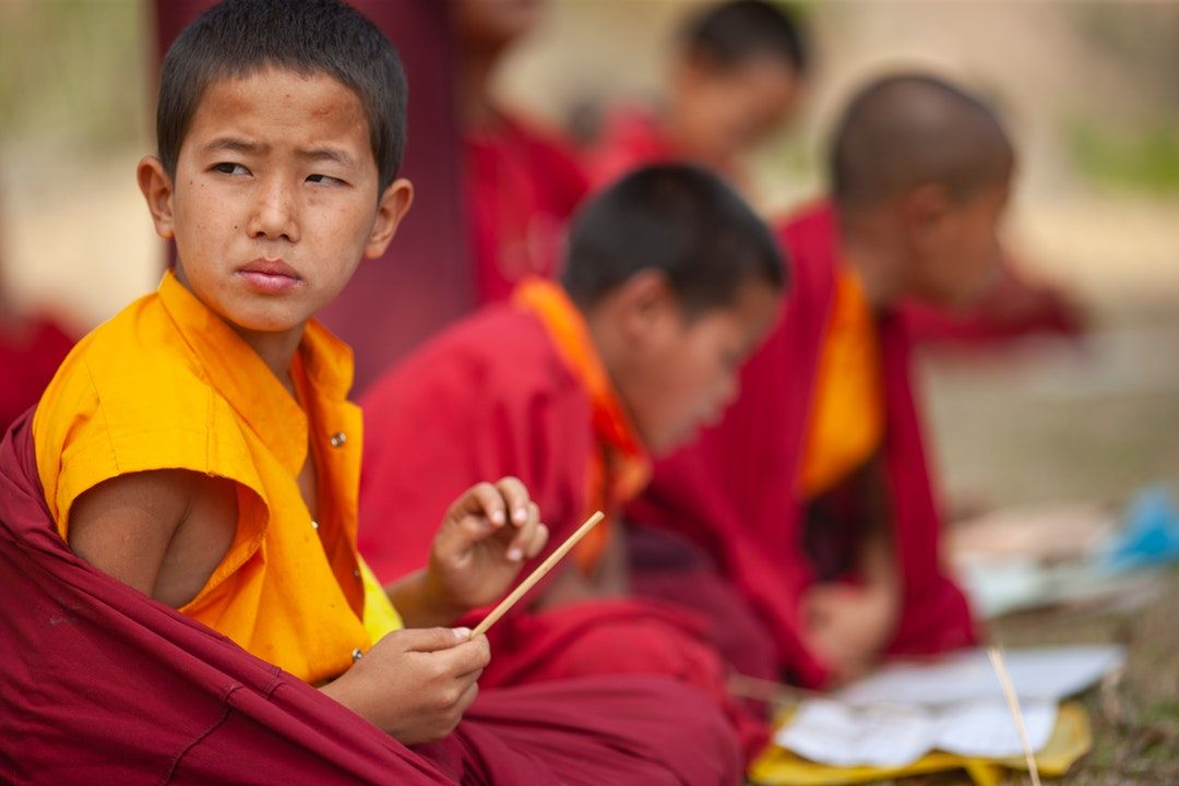selective focus photography of boy sitting in round