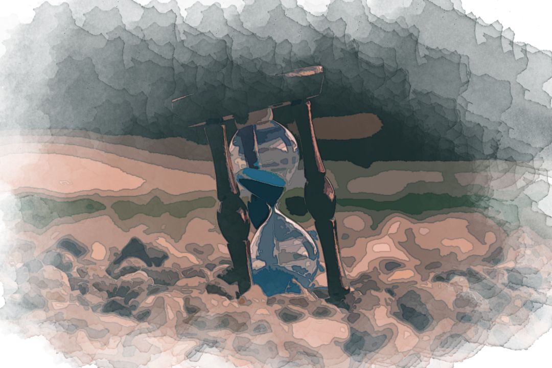 selective focus photo of brown and blue hourglass on stones