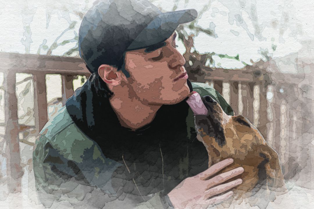 man petting brown dog