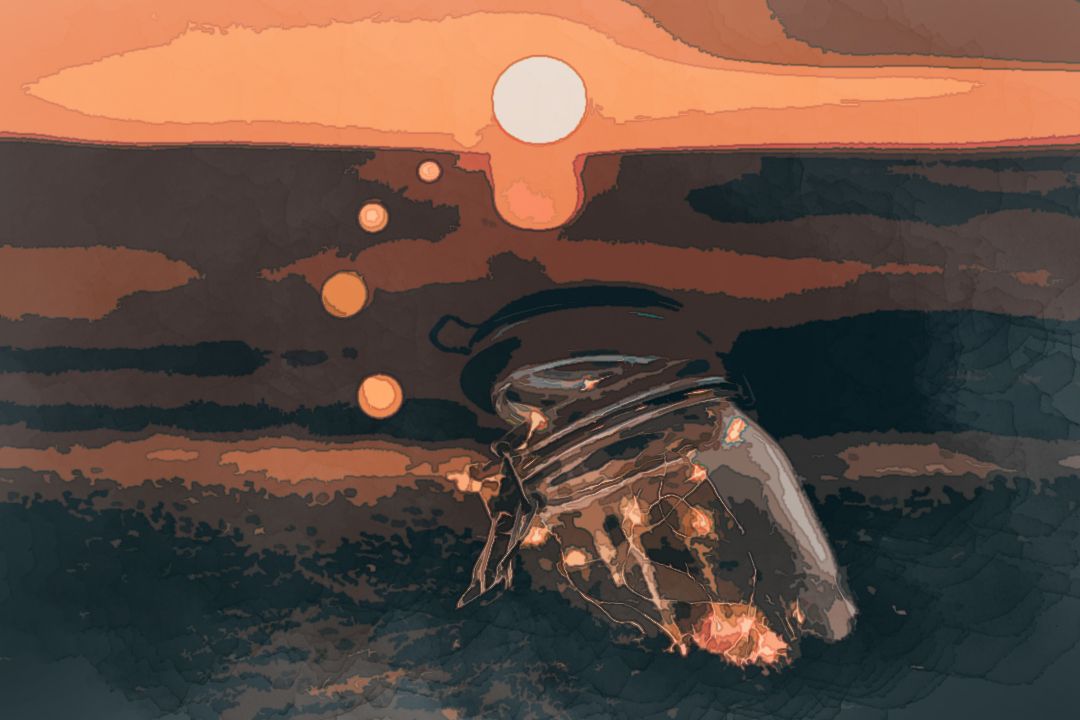 clear glass jar on sand