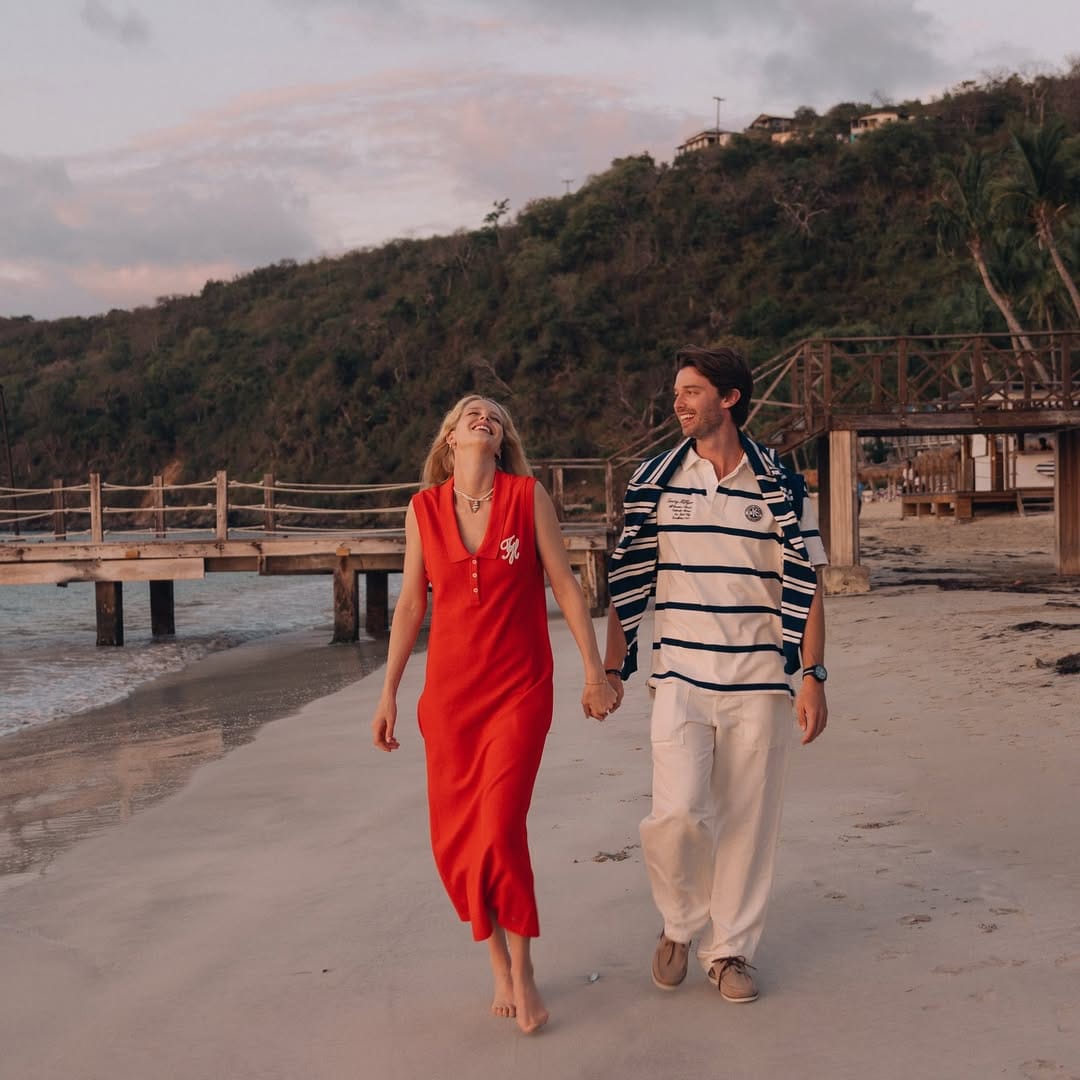Patrick Schwarzenegger and fiancée Abby Champion walking on the beach.