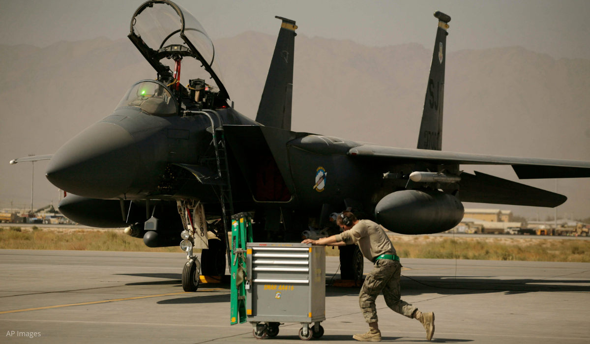 Air Force airman passes an F-15E Strike Eagle