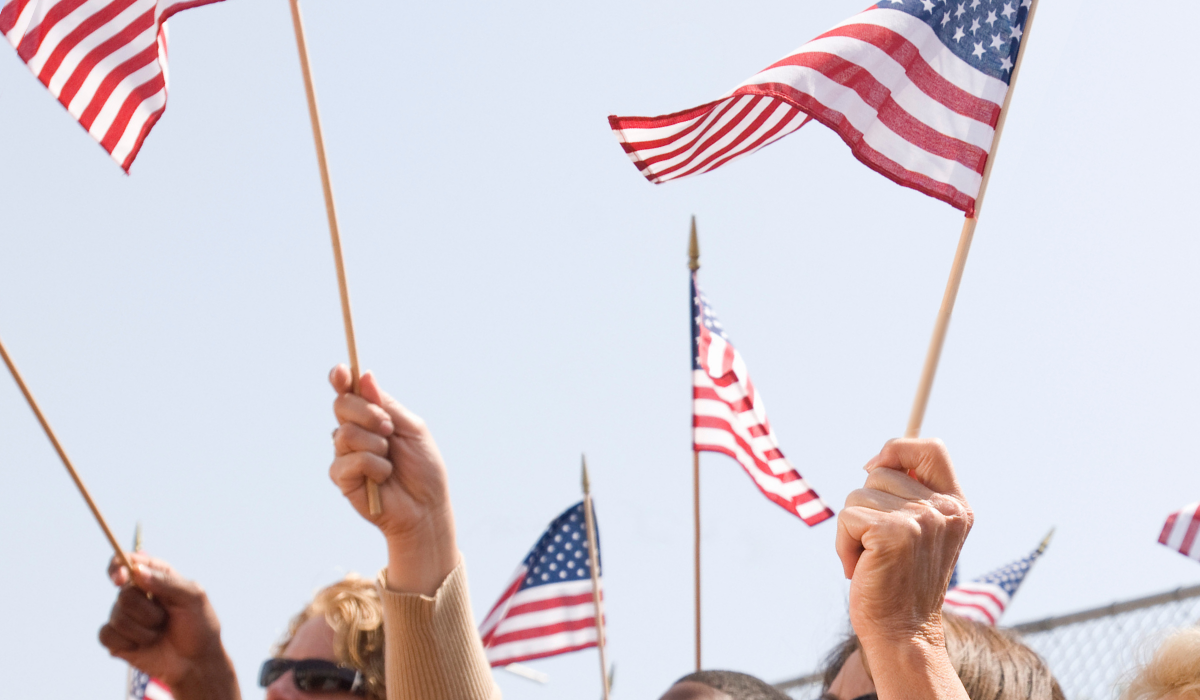 Crowd cheering with American flags