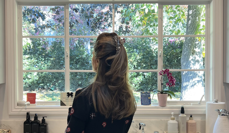 Maria Shriver at her kitchen window.