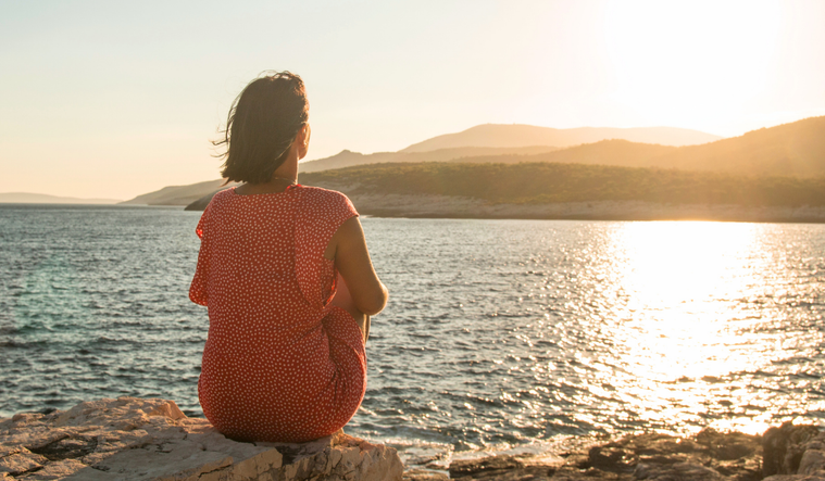 Woman staring at sunset
