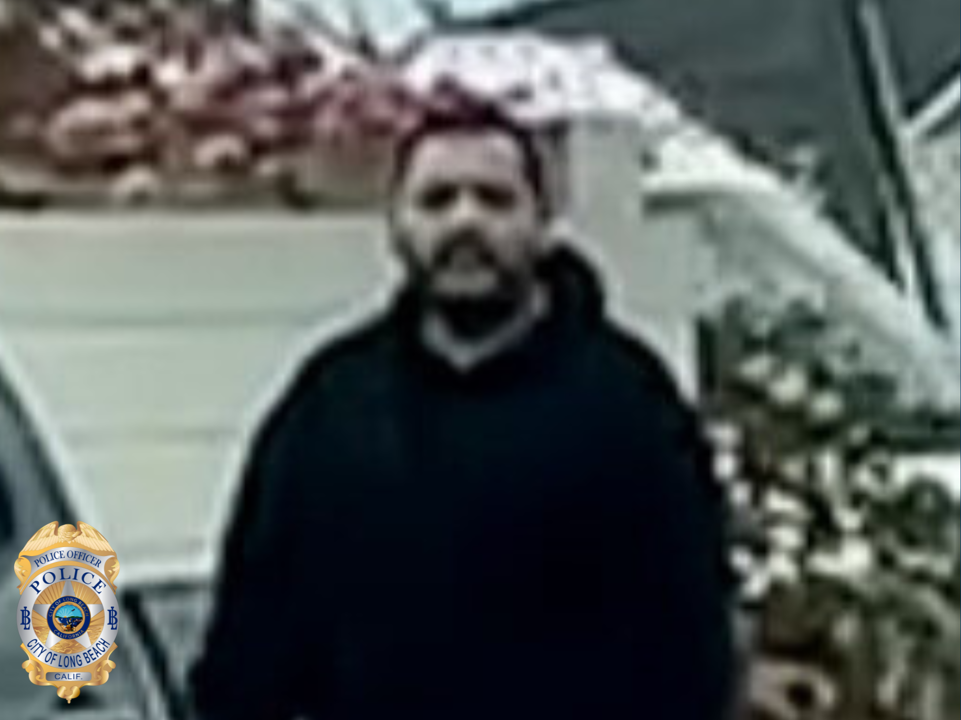 Blurry photo of a man wearing dark clothing.