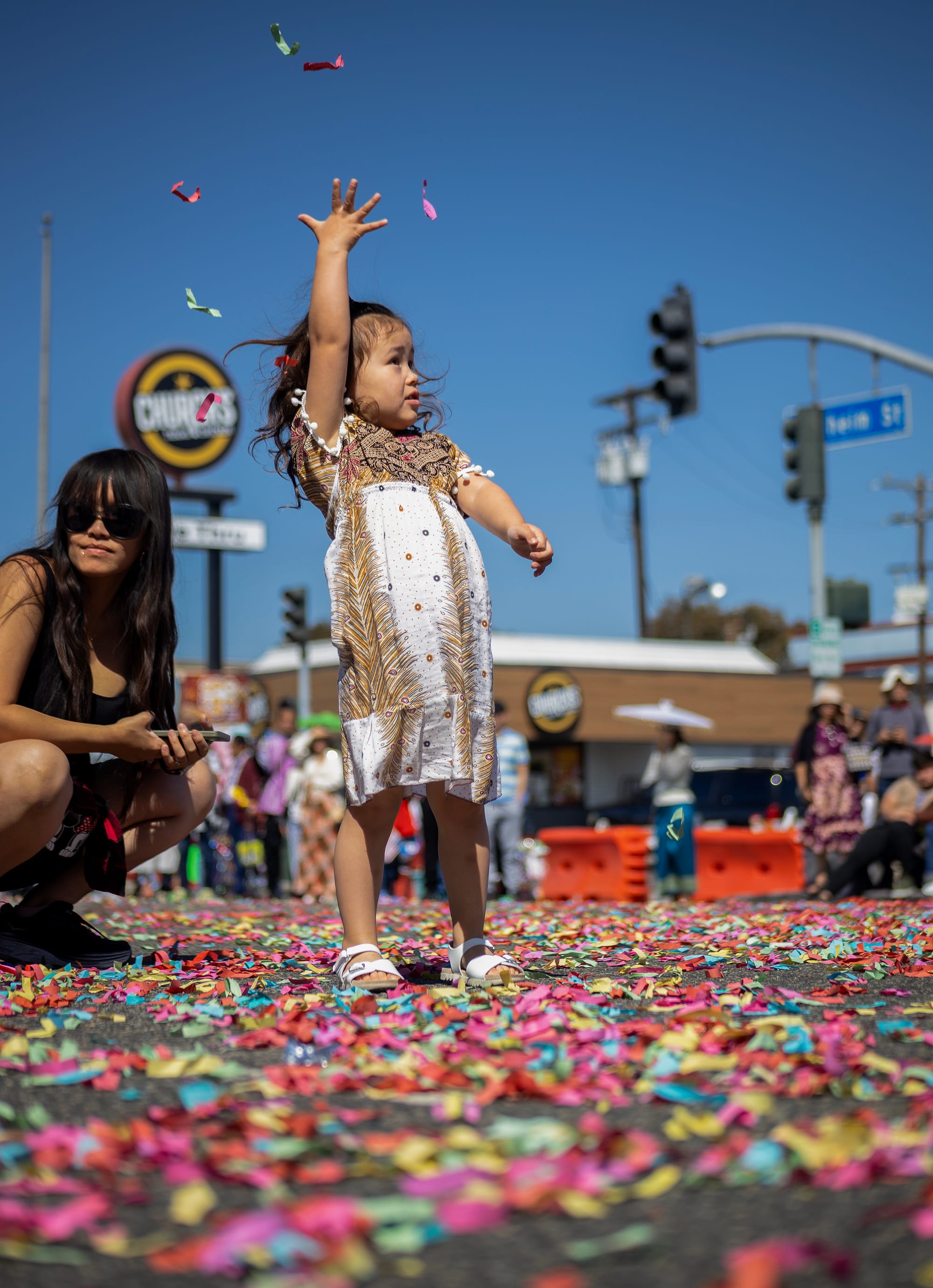 A child tosses confetti into the air.
