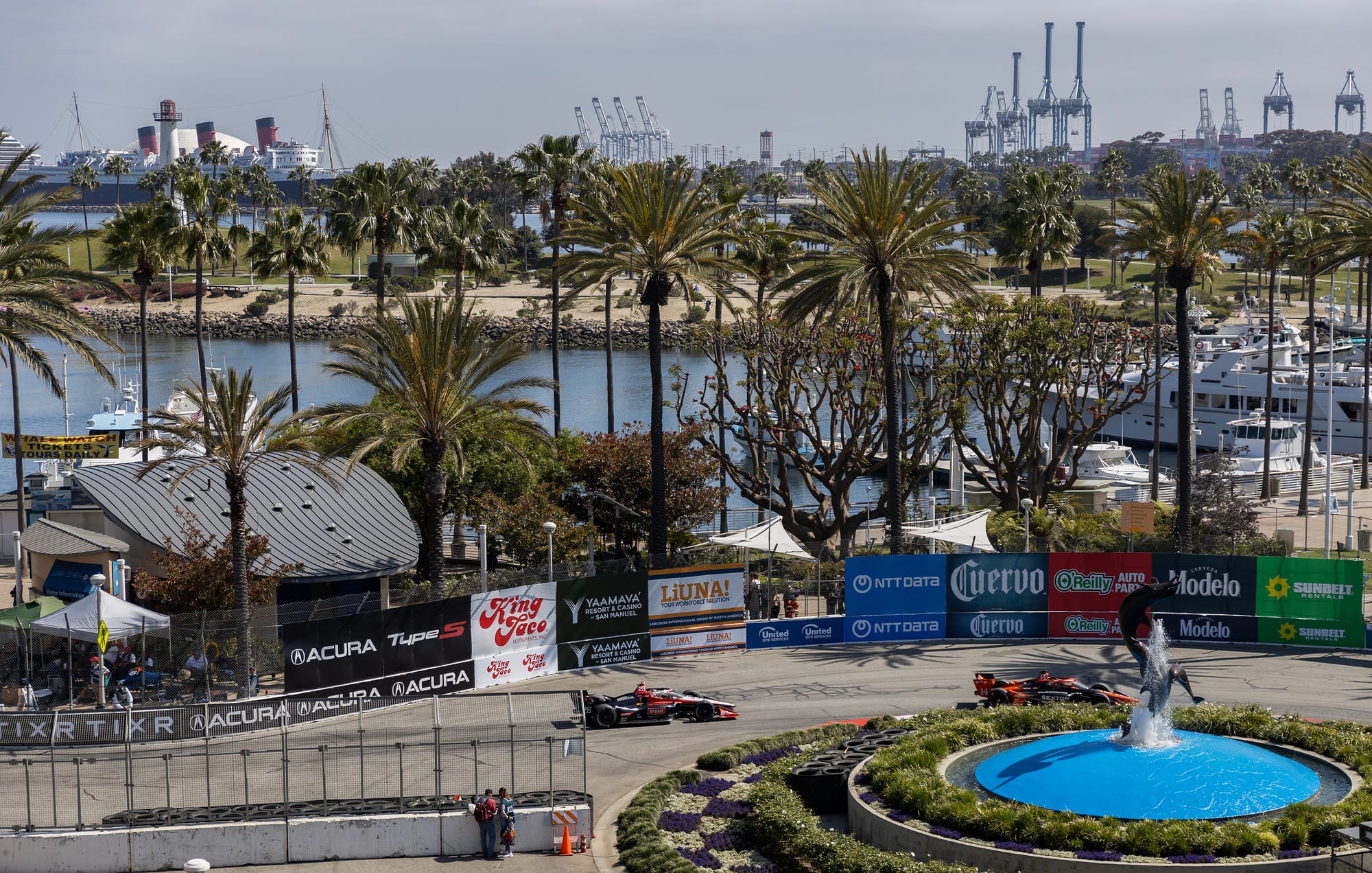 Two race cars speed on a track.