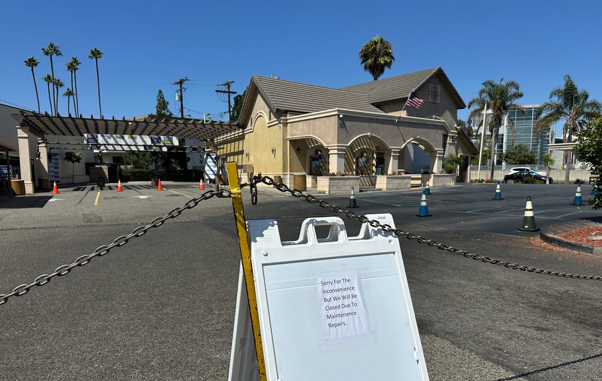 A small sign says a car wash is closed due to "maintenance repairs."