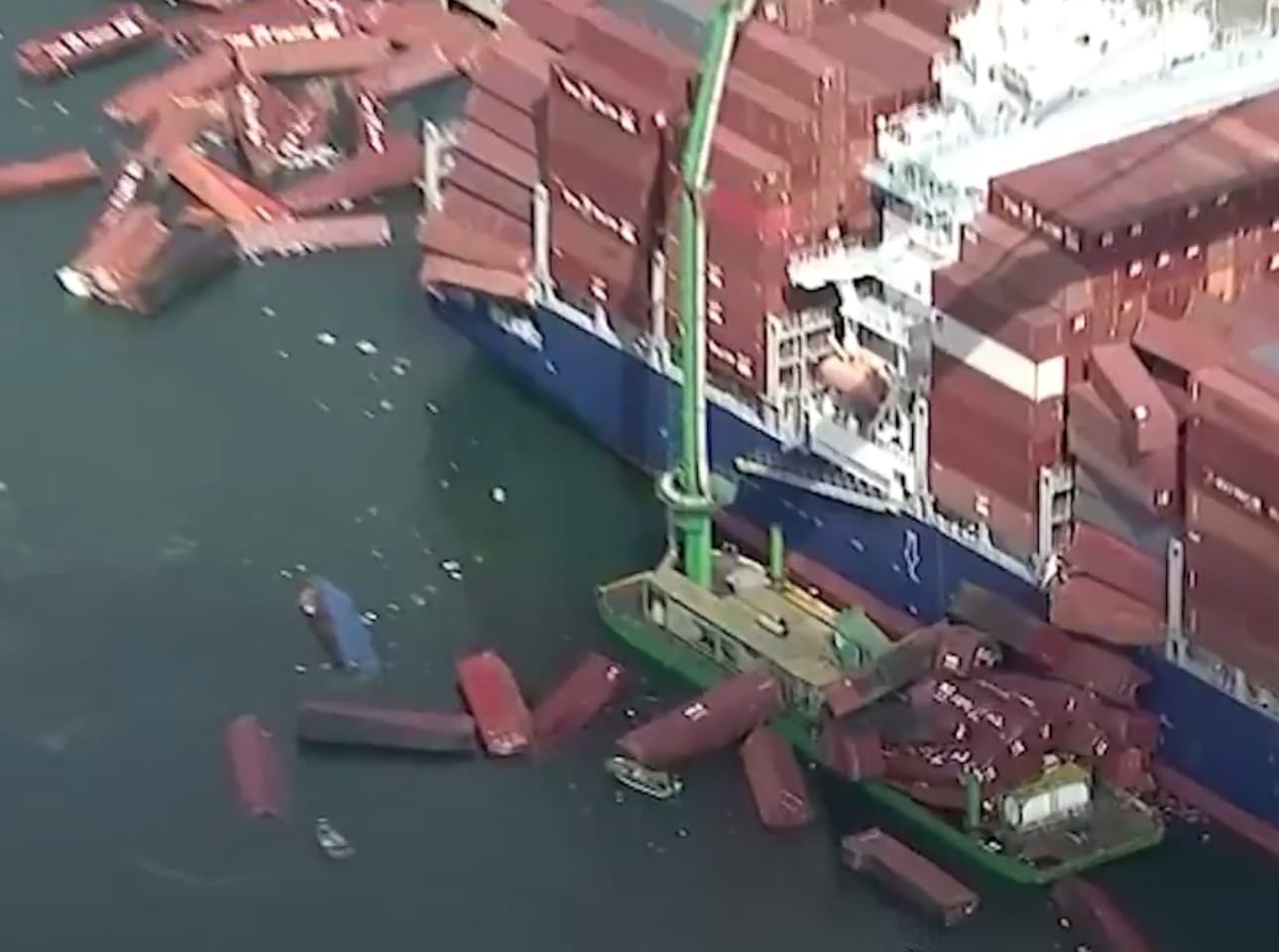 Containers floating around a freighter.