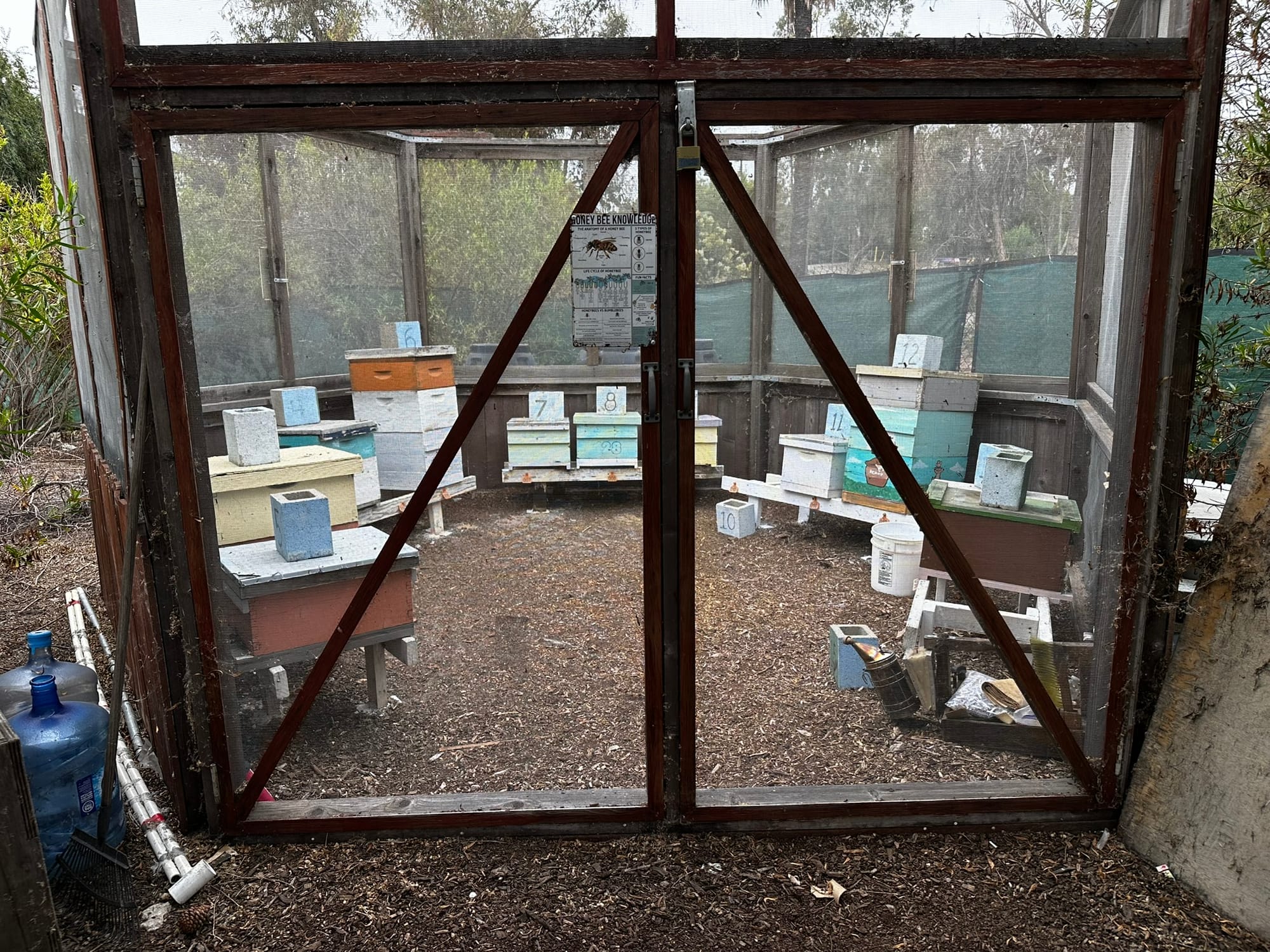 Stacks of wooden boxes sit in a horseshoe configuration inside a hexagonal enclosure.