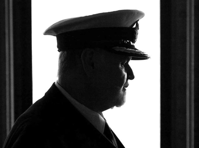 Silhouette of a man wearing a ship captain’s hat.
