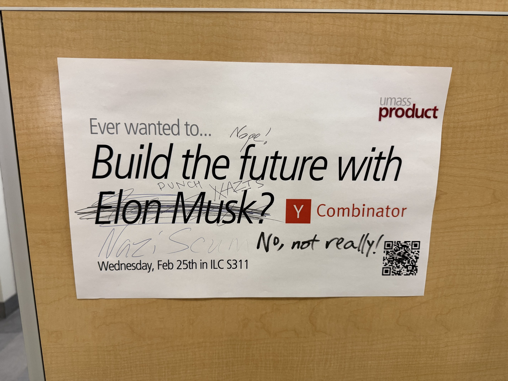 An ad for the company Y Combinator that was graffiti'd to call Elon Musk a Nazi.