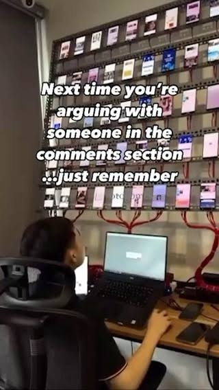 a modern day bot farm with the caption "Next time you're arguing with someone in the comments section... just remember"