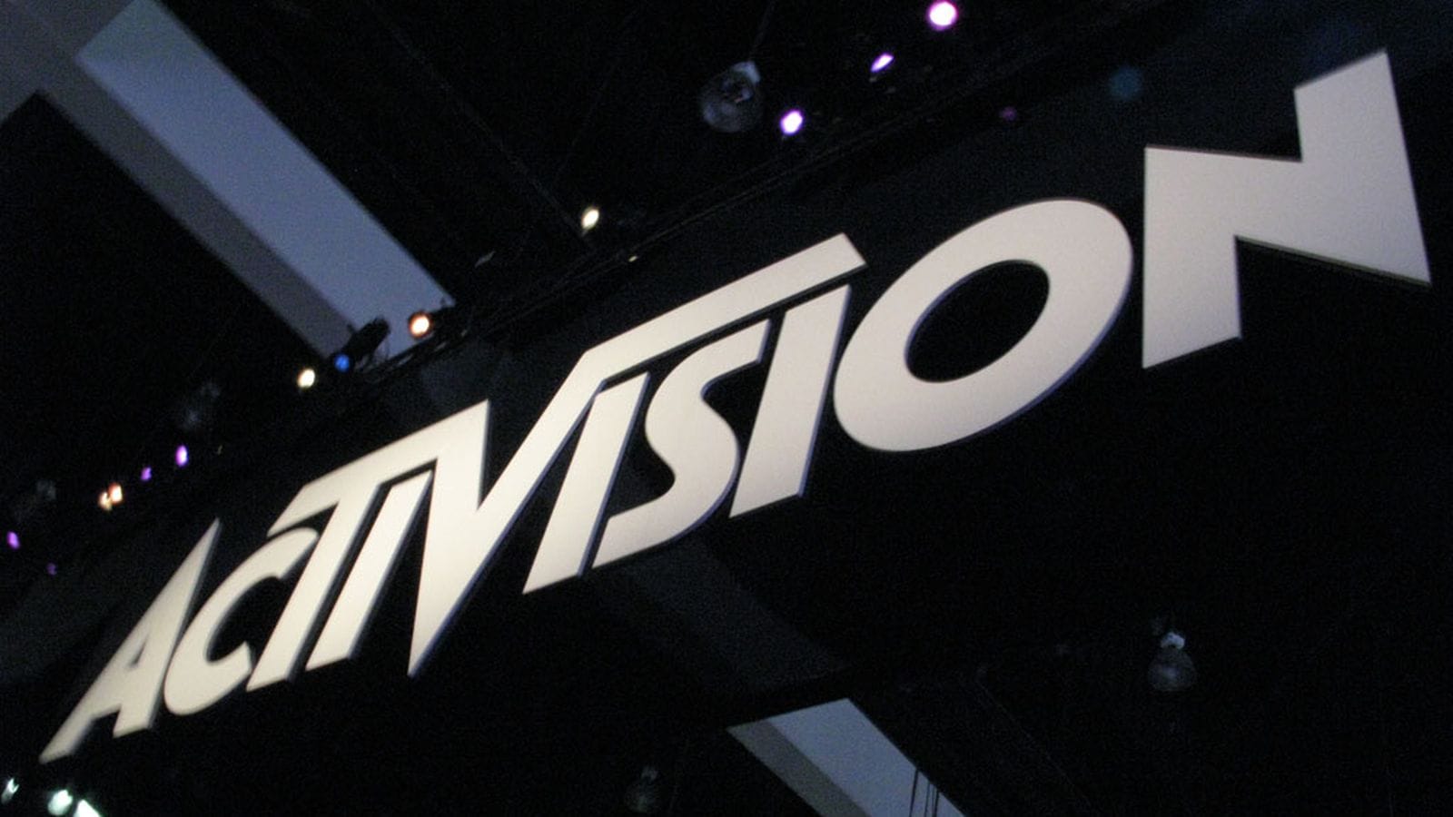 The Activision logo in 3D font suspended to a convention ceiling.