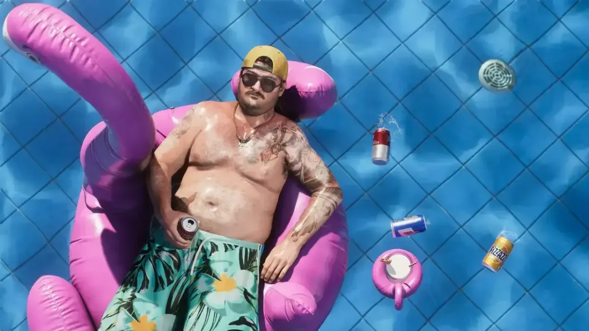 A tatooed man in a swimshort on a pink flamingo boey in a pool with floating empty cans.
