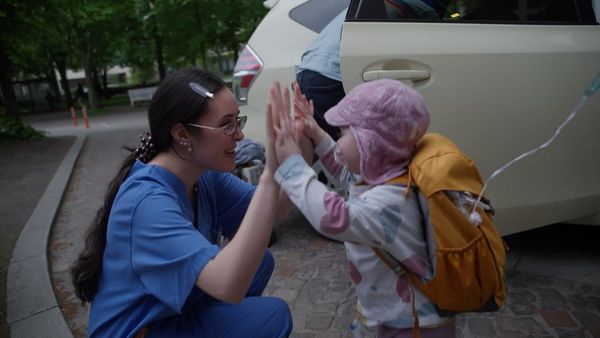 Pflegerin Sude gibt ihrer kleinen Patientin Alice ein High Five