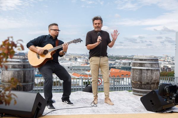 Thomas Anders singt mit Mikrofon auf einer Dachterrasse in Berlin, neben ihm ein Gitarrist