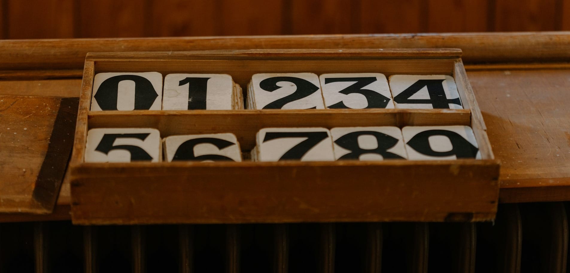 A close up of a wooden box with numbers on it