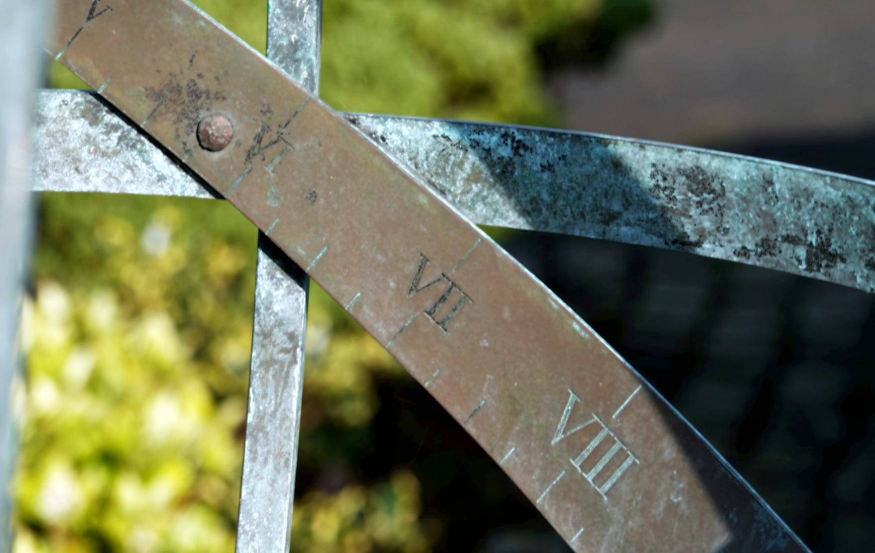 Close-up of an old sundial with roman numerals.