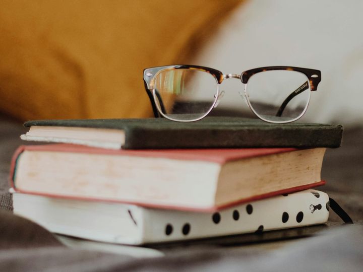 glasses on a pile of books. 