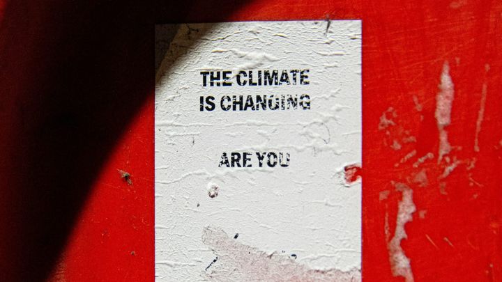 a wrinkled paper flyer says "the climate is changing...are you"