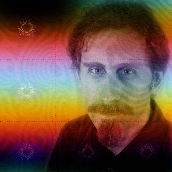 Portrait of Erik Davis with wavy hair, moustache and goatee in a dark shirt, tinted in a red, blue and yellow rainbow colour wash.