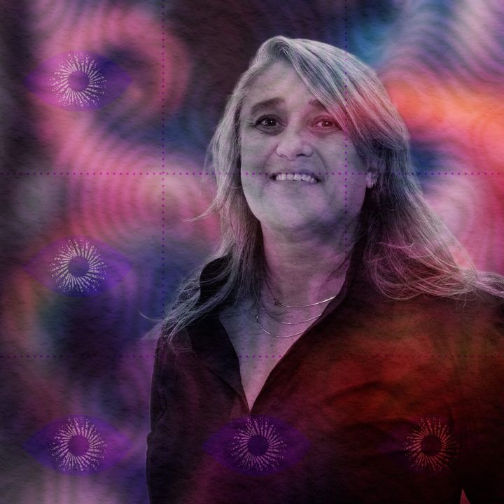 Portrait of Gül Dölen, smiling with long grey hair and a black shirt, in a violet-and-pink psychedelic colour wash.