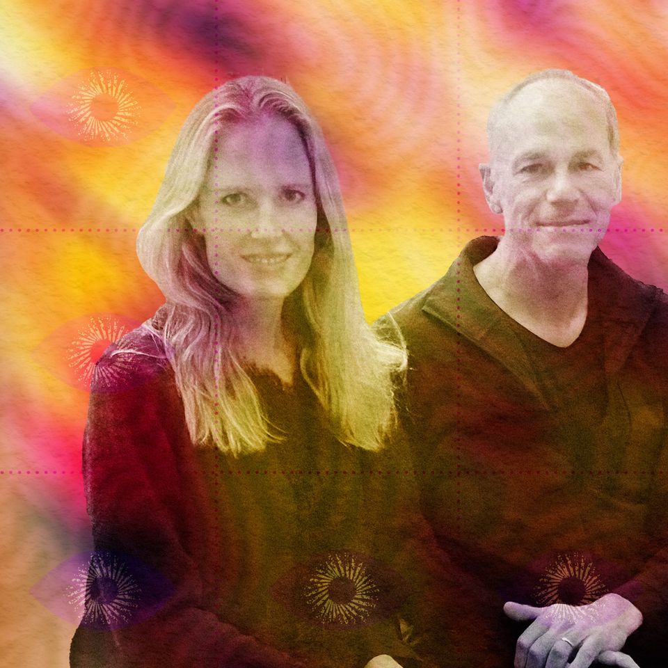 Portrait of Kari and Marcelo Gleiser seated side by side, smiling, against a fiery orange-and-pink psychedelic swirl.