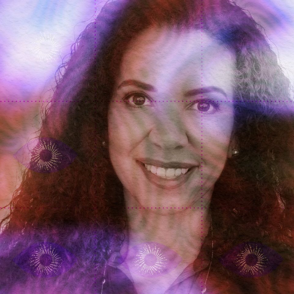 Portrait of Spring Washam smiling broadly at the camera, long dark curls, in a violet-and-magenta psychedelic colour wash.