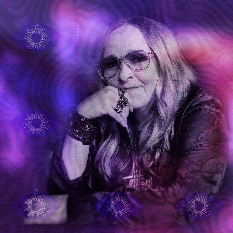 Portrait of Melissa Etheridge in aviator glasses, chin resting on her ringed hand, in a violet-and-magenta colour wash.