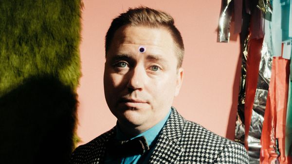 Picture of me in a colourful room with a googly eye on my forehead.