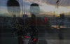 A reflection of two people in a window.