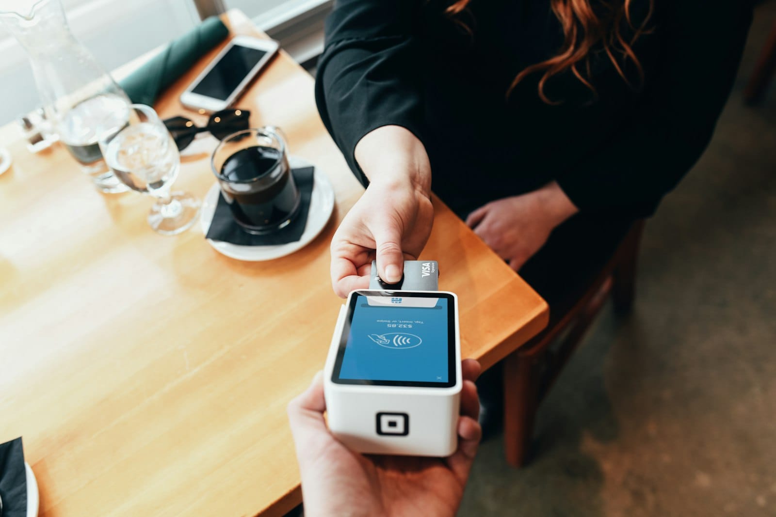 A person holding a card payment terminal