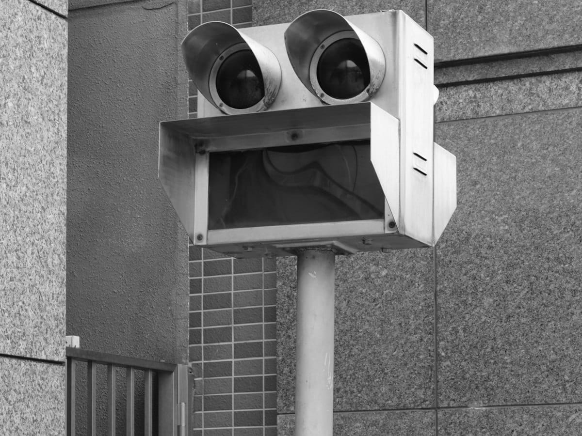 A traffic signal mounted on a pole against the sky