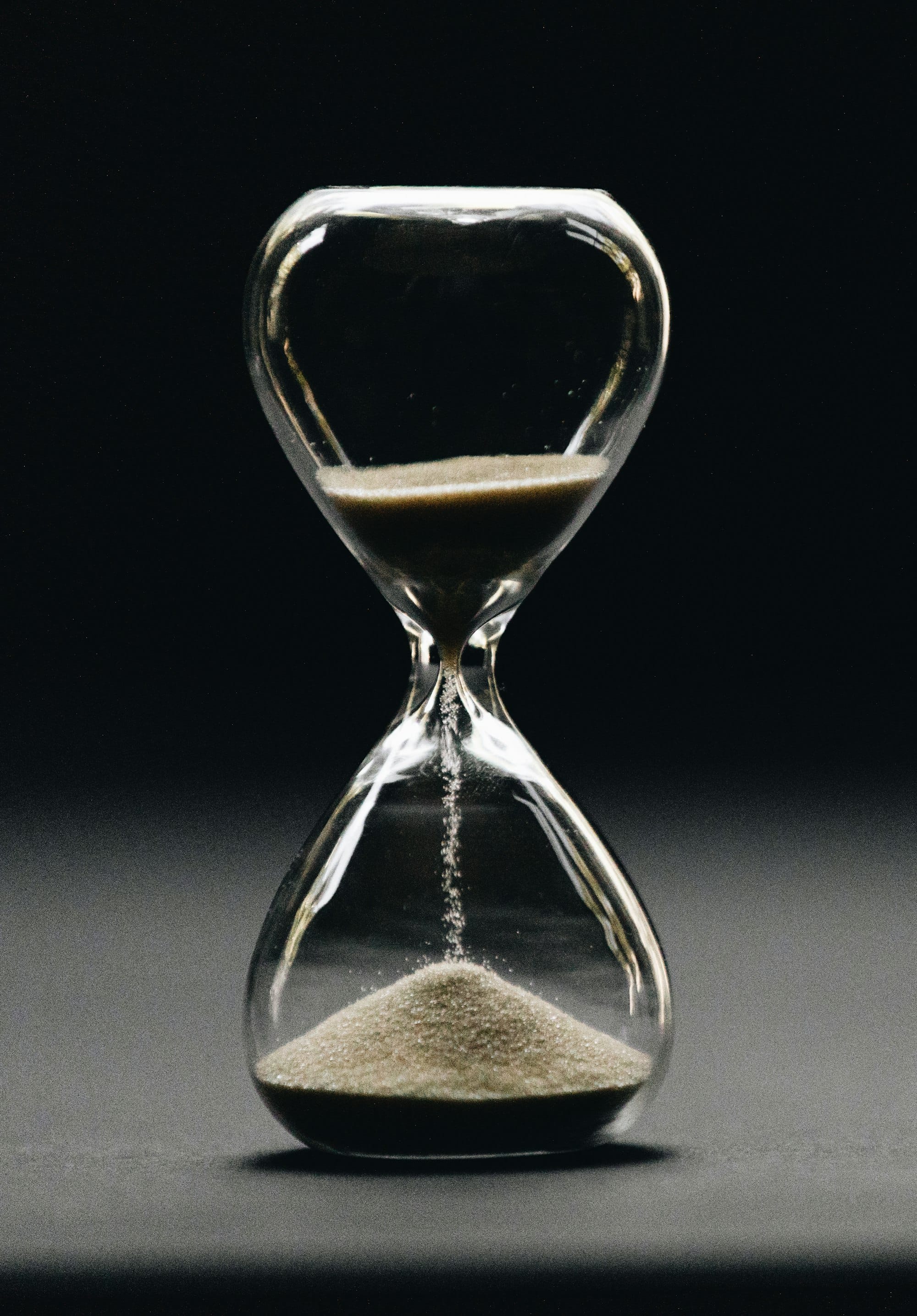 A clear hourglass with sand running through it