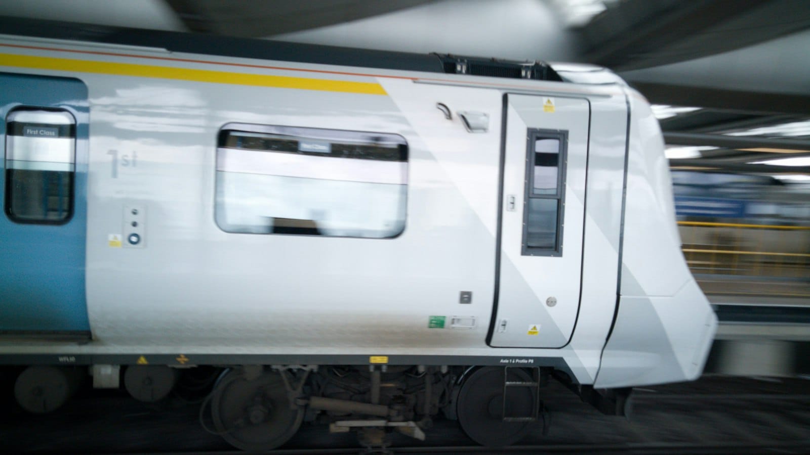 A white Thameslink Class 700 train arriving at a London platform
