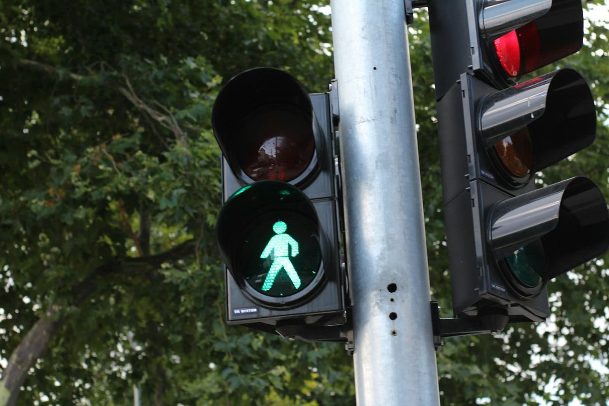 A pedestrian traffic light showing a green walking figure