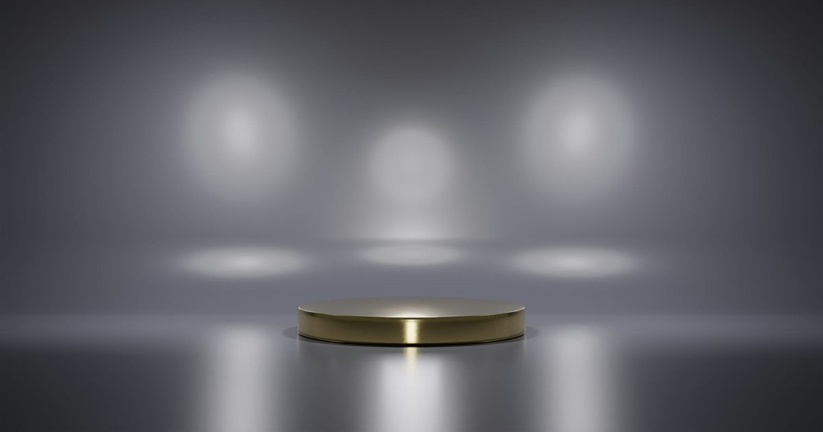 An empty lit podium in a grey room
