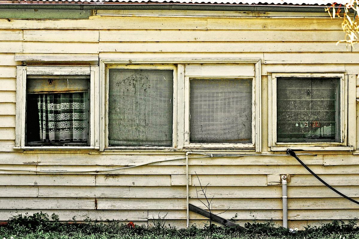 An old run down house with a broken window