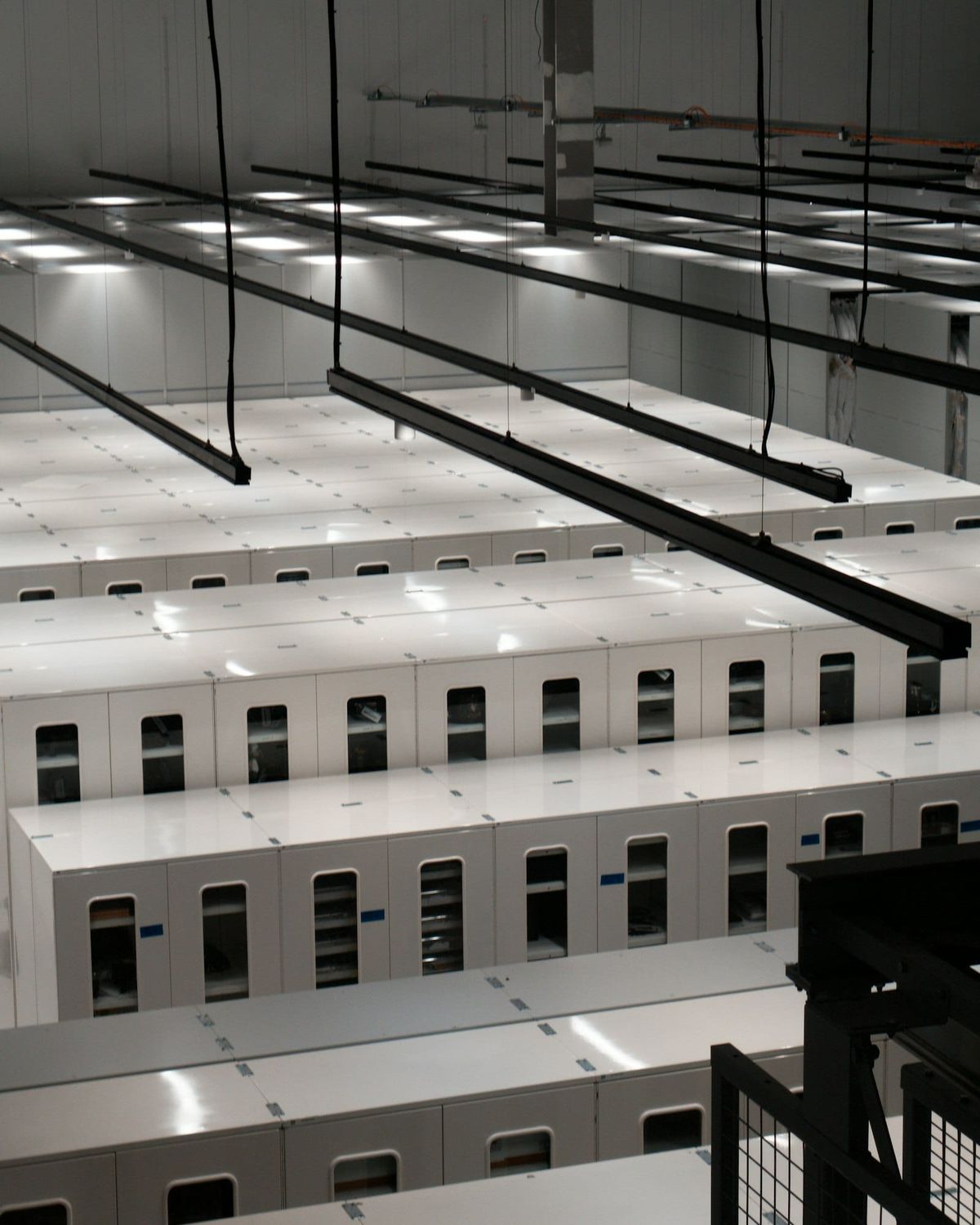 Rows of white server cabinets in a data centre in London