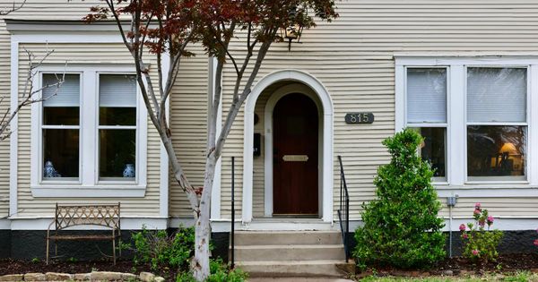 Front steps and arched doorway of a house with a path leading up to it