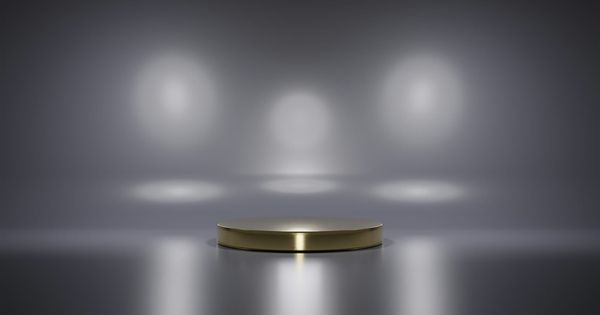 An empty lit podium in a grey room
