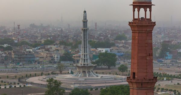 Minar-e-Pakistan and a minaret of the Badshahi Mosque above Lahore