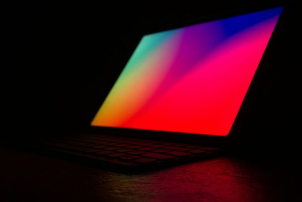 A laptop open in a dark room
